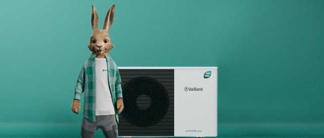 the vaillant hare standing in front of a heat pump on a green background