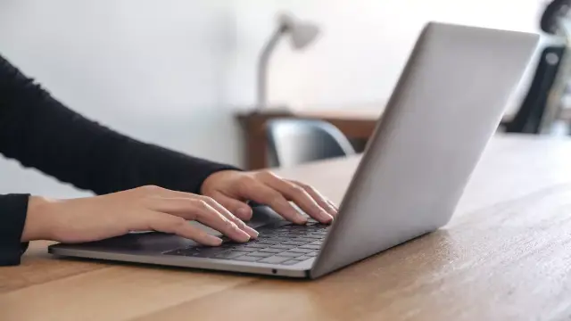 open laptop with fingers typing