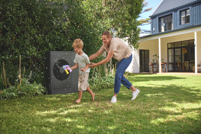 a heat pump in front of a brick wall