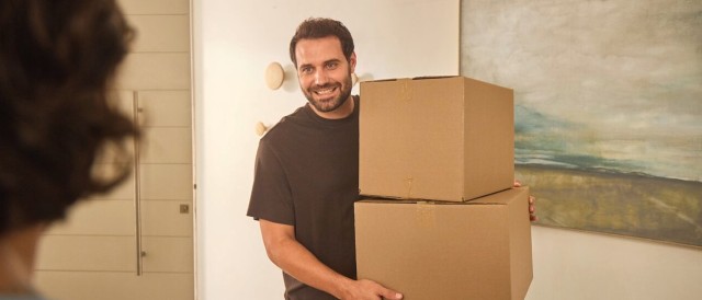 Man holding two cardboard boxes
