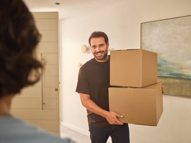 Man holding two cardboard boxes