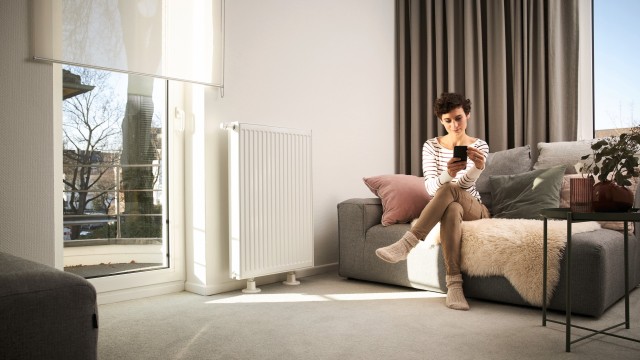 a woman sat on her phone in her living room