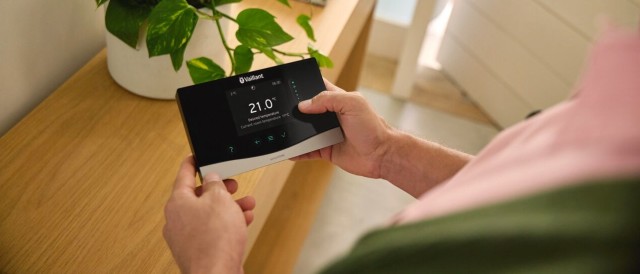 Person holding a Vaillant heating control