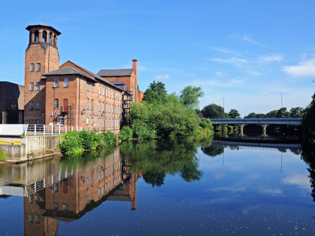 Derby silk mill, a red brick old building with a large lake