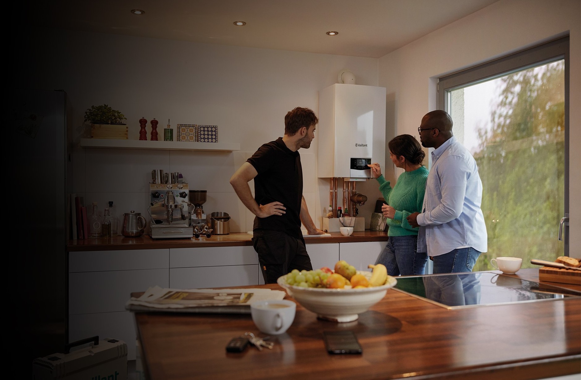 homeowners talking to installer in kitchen whilst looking at ecoTEC plus boiler