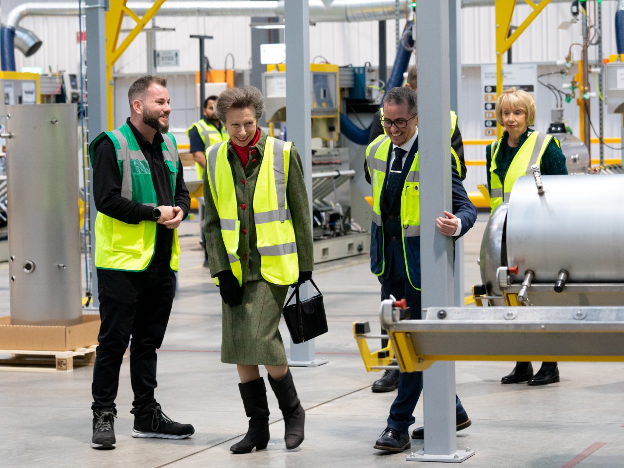 Princess Anne walking with people in the factory