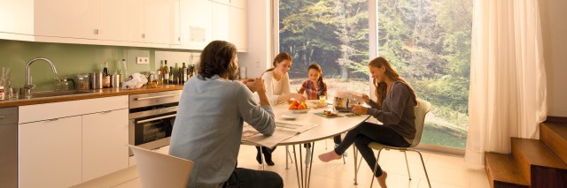 family sitting around a table in the kitchen