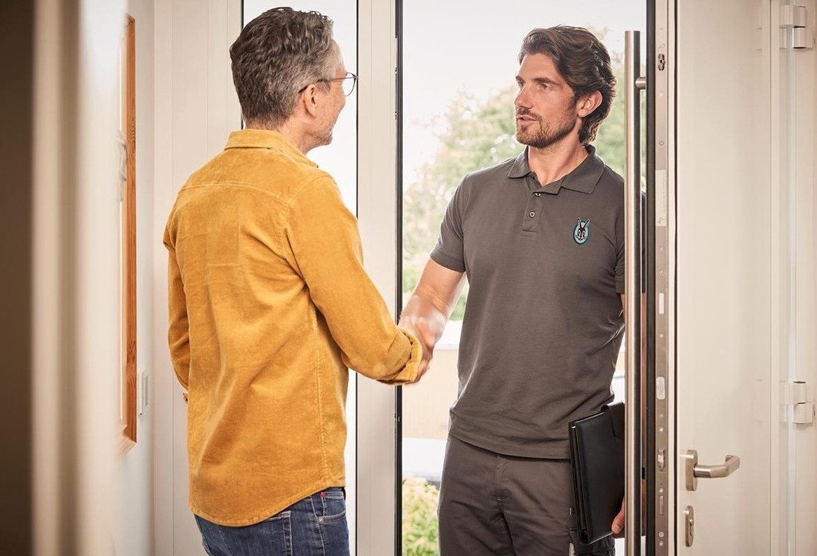 Installer shaking hands with a homeowner