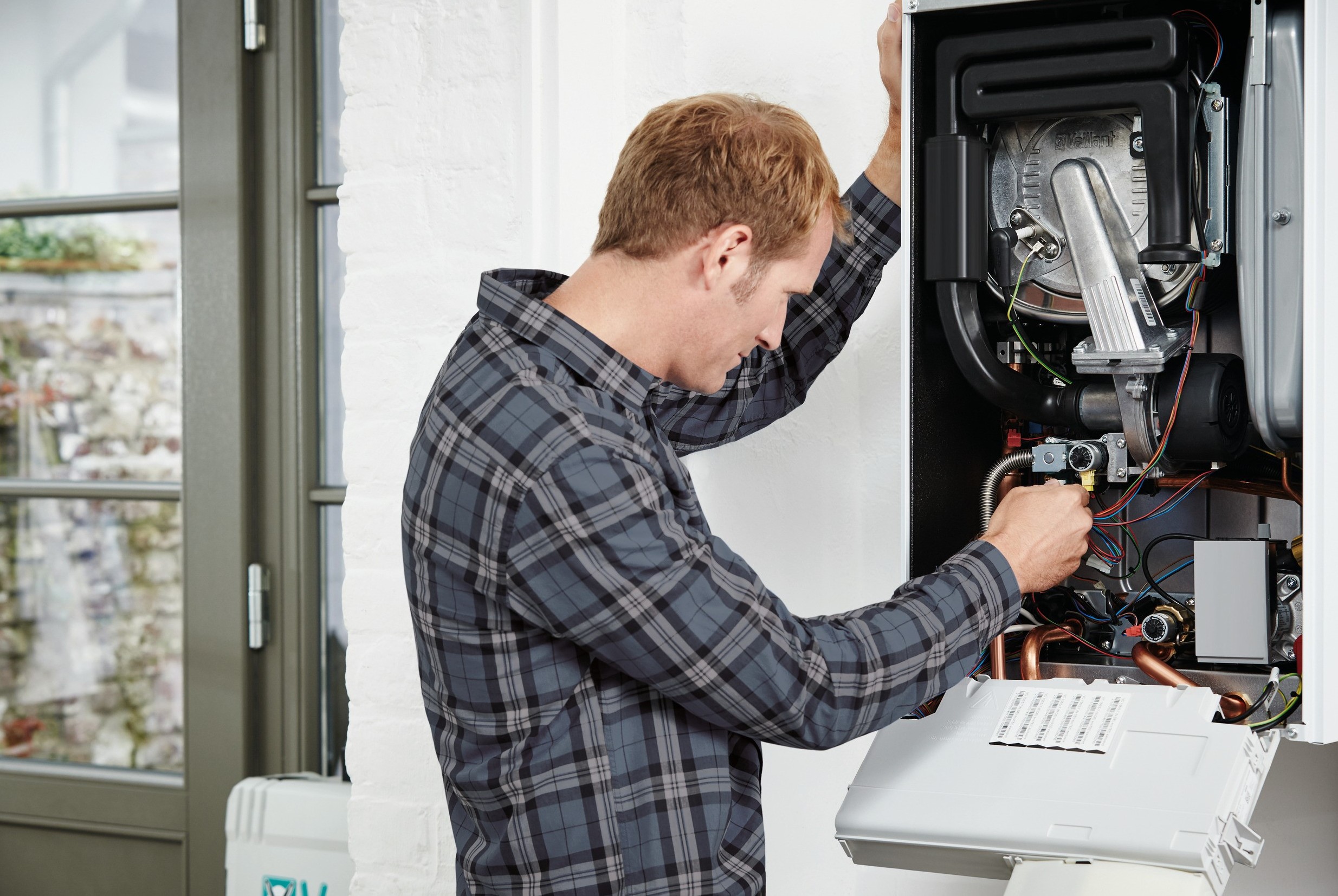 installer working on a boiler