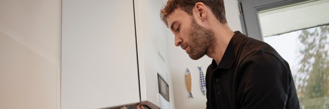 installer fixing the underneath of a boiler