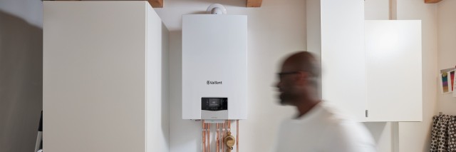 man doing his washing with boiler in the background