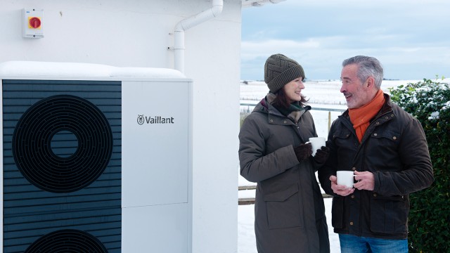 couple standing in front of an aroTHERM plus 