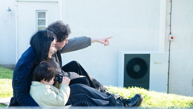 family sat on the grass