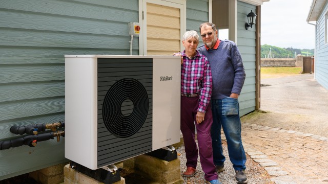 couple standing in front of an aroTHERM plus 