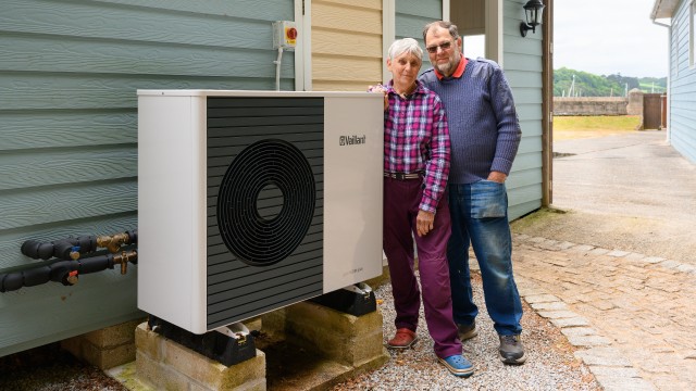 couple standing in front of an aroTHERM plus 