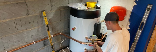 back of an installer carrying out work on a cylinder