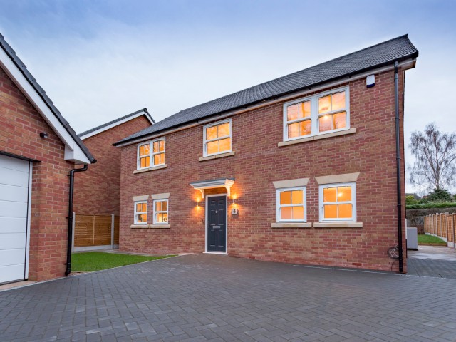 red brick house with lights on 