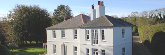 Aerial view of a large white countryside house