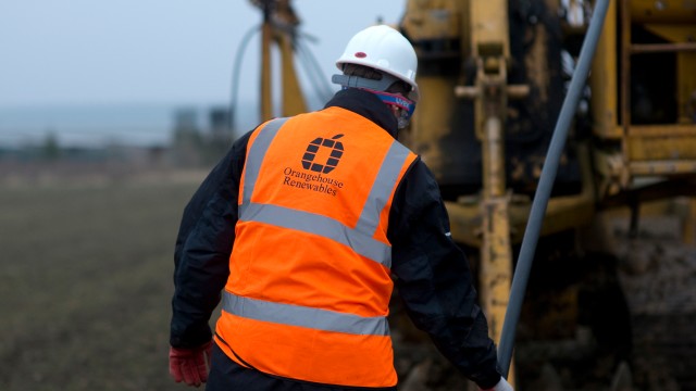 back of a man wearing a high vis jacket and helmet