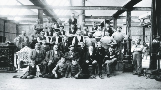 a group photo of male factory workers