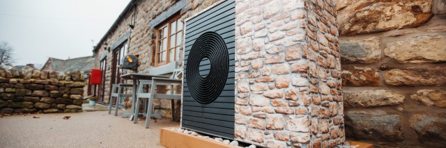 an aroTHERM plus heat pump wrapped in brickwork