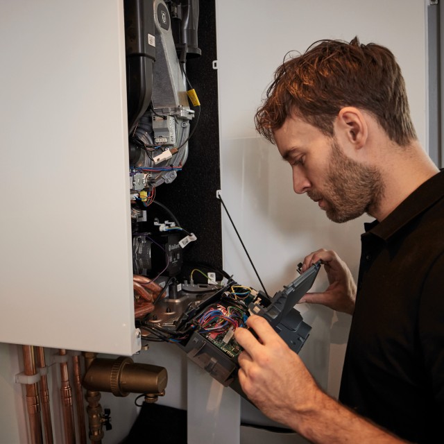 man doing work inside a boiler