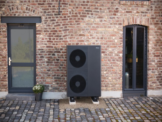 double stacked aroTHERM plus heat pump in front of a brick wall