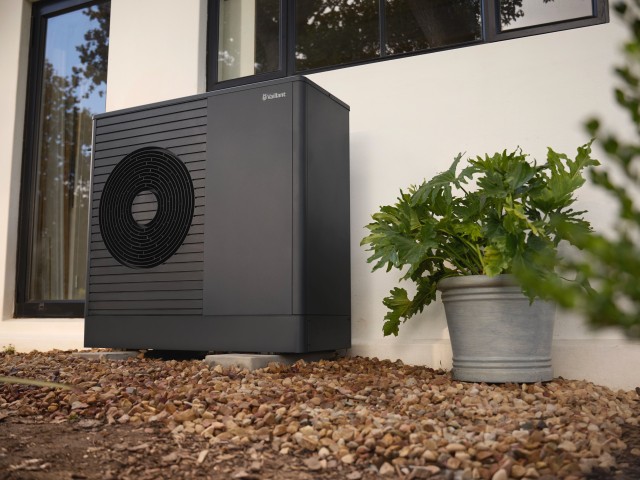 heat pump at the side of a wall