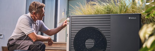 two men fitting a Vaillant aroTHERM plus heat pump