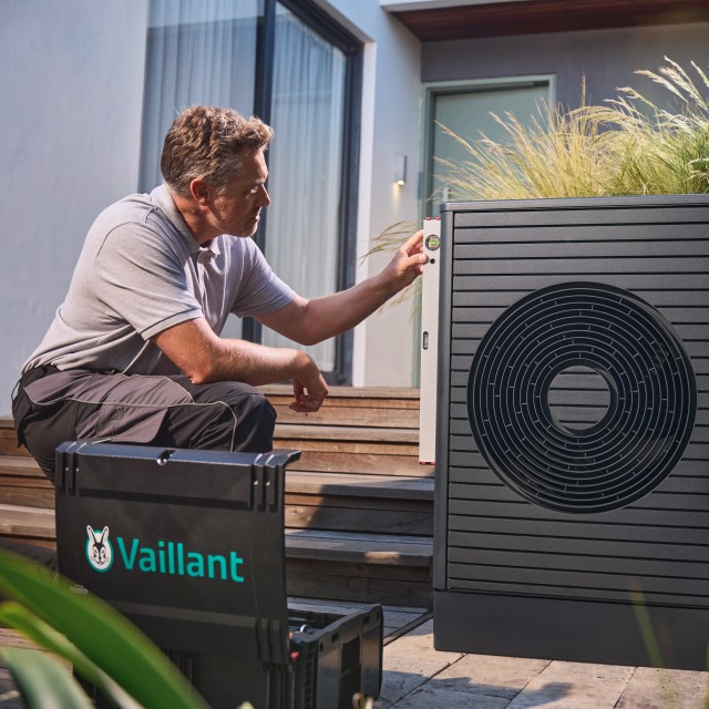 Male installer installing a heat pump