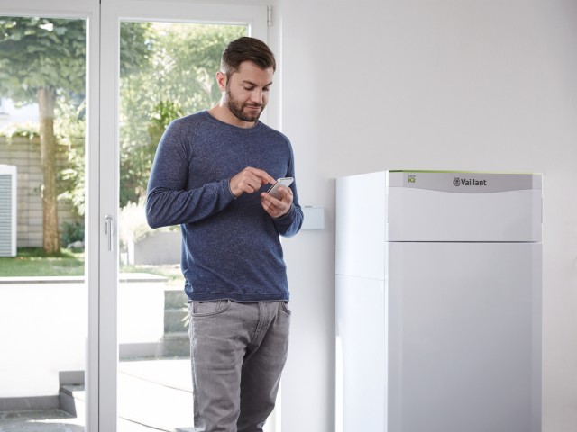 Man stood next to a Flexotherm heat pump