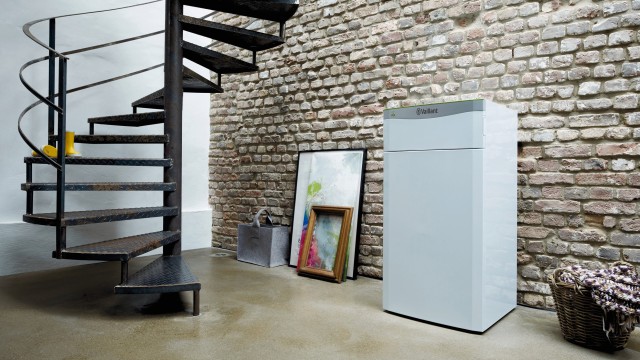 ground source heat pump unit inside home with stairs and paintine