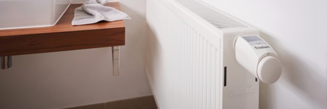 top of a radiator with a TRV on the end in a bathroom