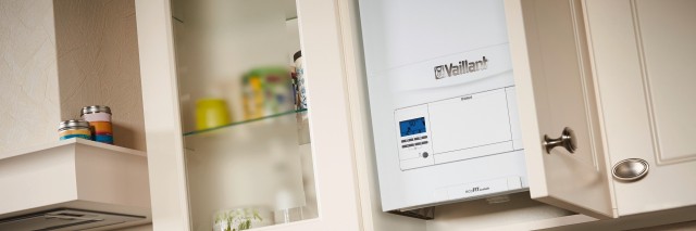 a boiler in a kitchen cupboard