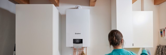 woman doing washing with a boiler in the background