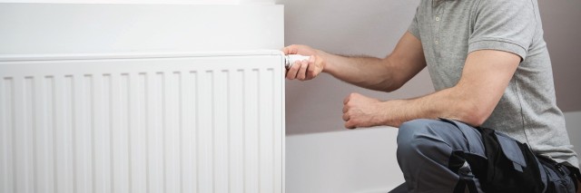 Man inspecting a radiator