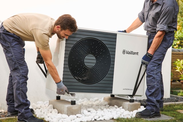 two heat pump installers fitting a heat pump