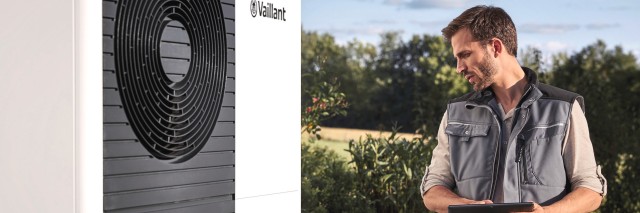 installer standing in front of a heat pump