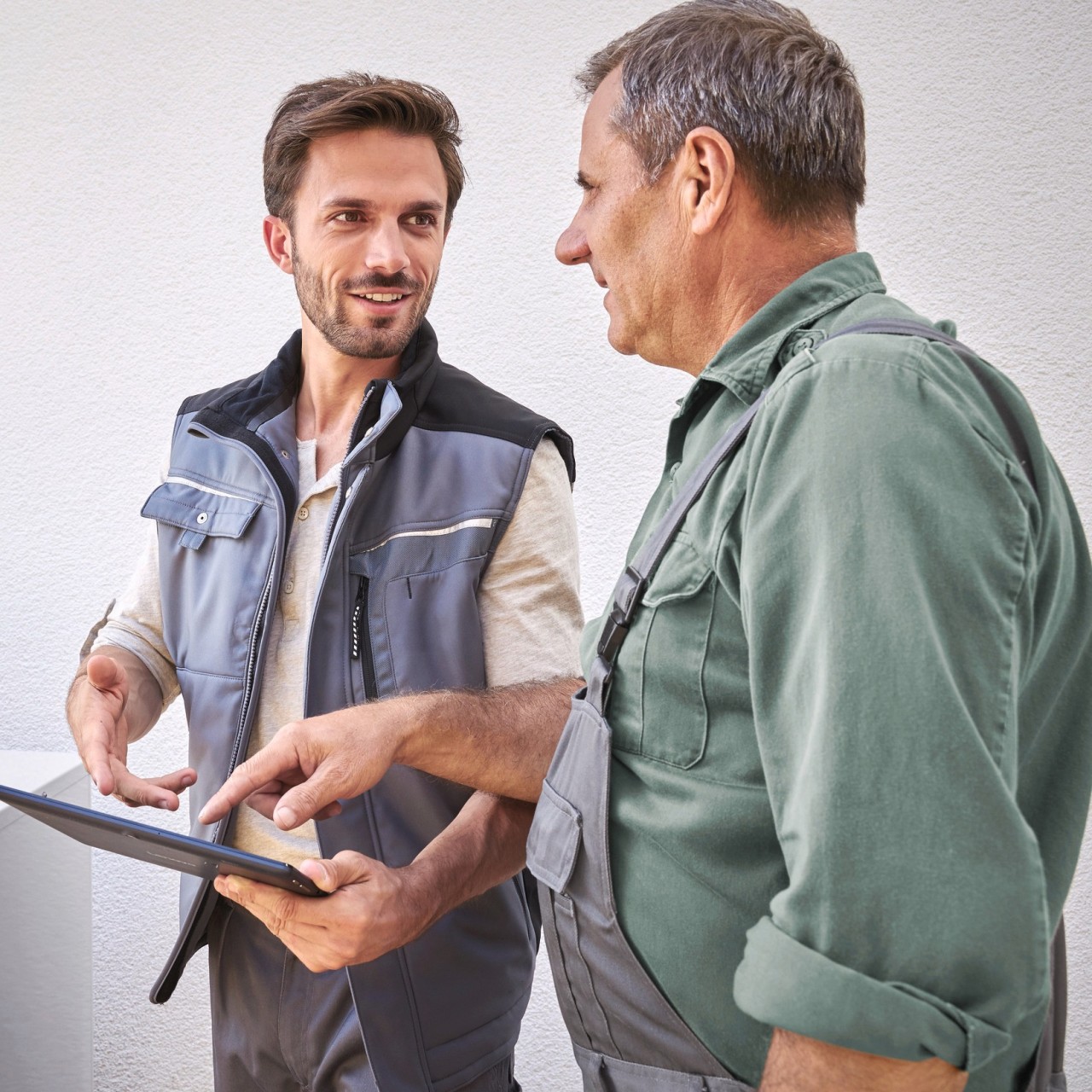 two men looking at a heat pump