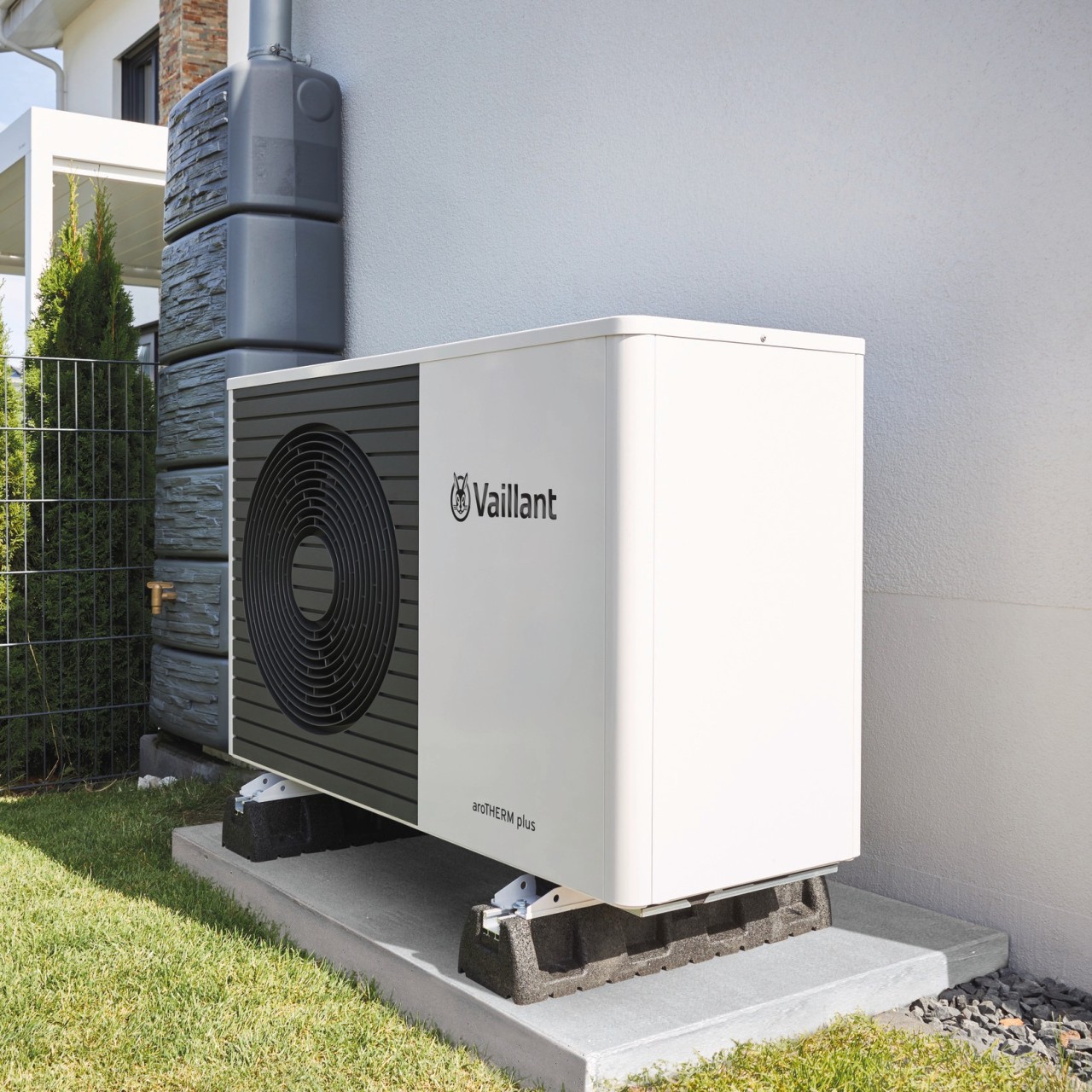 heat pump unit outside a white wall.