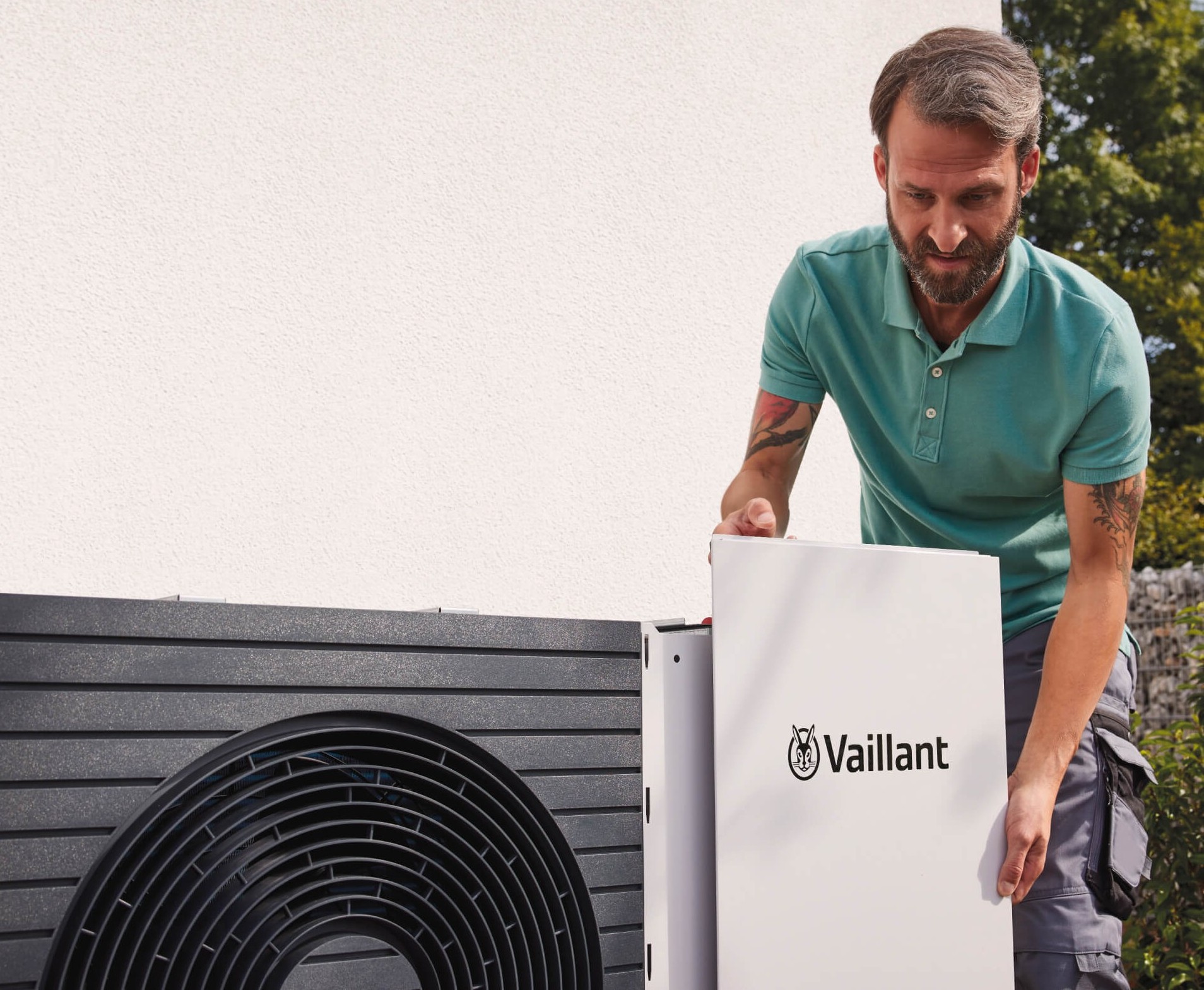 installer putting the front panel of a heat pump on. 