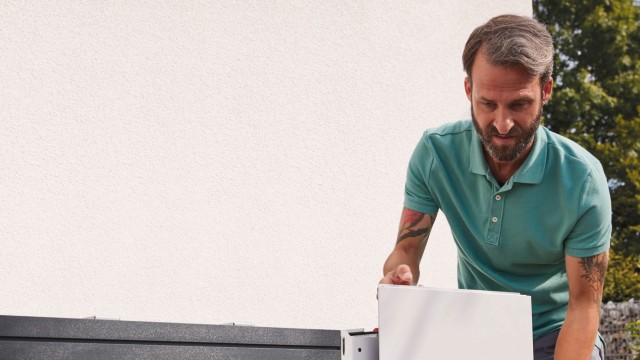 installer putting the front of a vaillant heat pump
